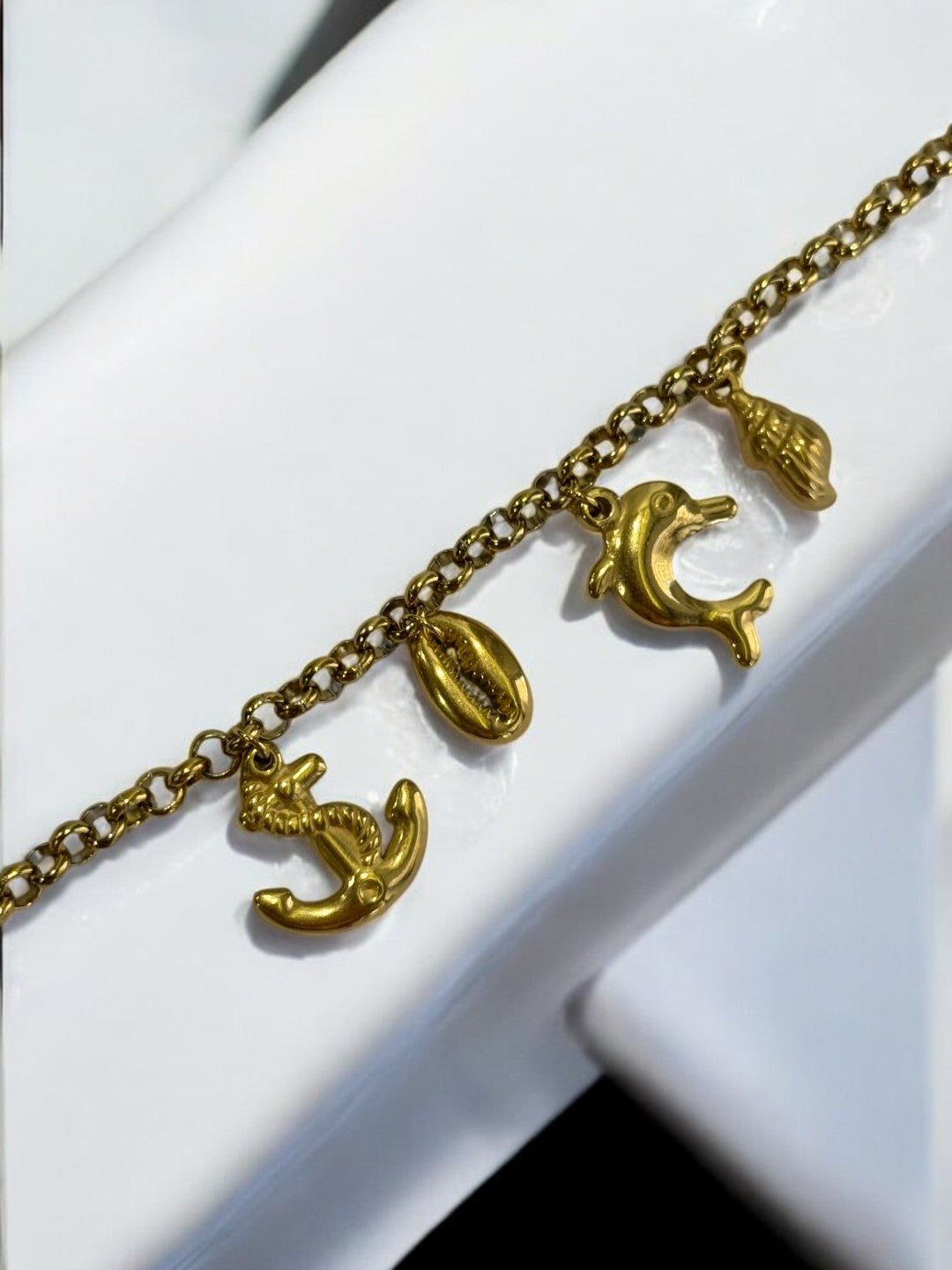 GOLDEN CHAIN BRACELET WITH CHARM LIKE ANCHOR, EYE CONCH AND DOLPHIN