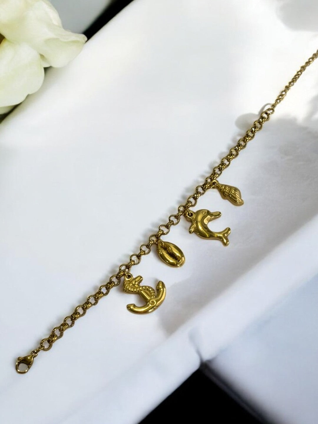 GOLDEN CHAIN BRACELET WITH CHARM LIKE ANCHOR, EYE CONCH AND DOLPHIN