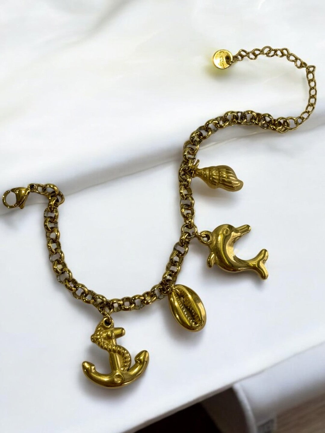 GOLDEN CHAIN BRACELET WITH CHARM LIKE ANCHOR, EYE CONCH AND DOLPHIN