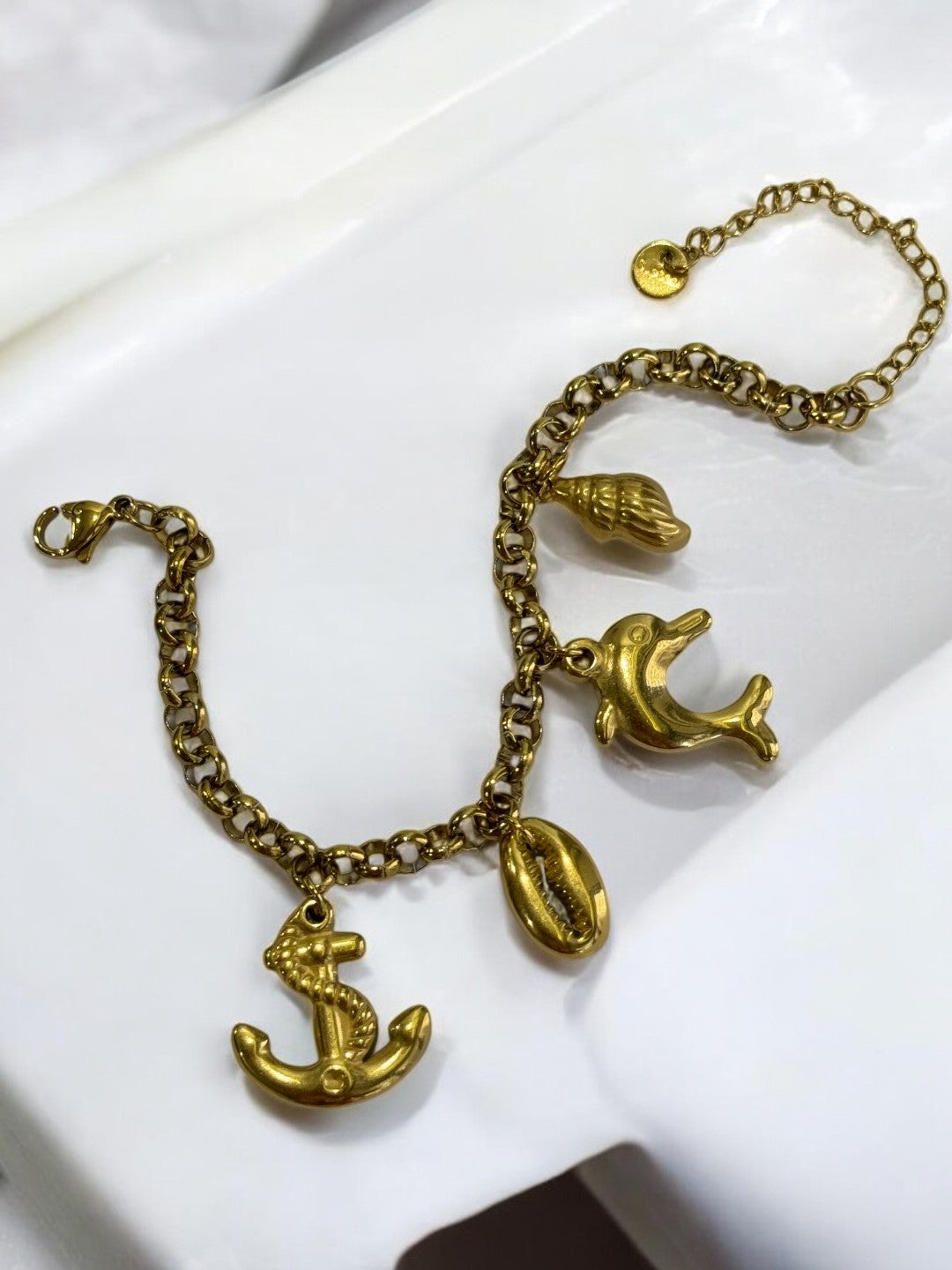 GOLDEN CHAIN BRACELET WITH CHARM LIKE ANCHOR, EYE CONCH AND DOLPHIN