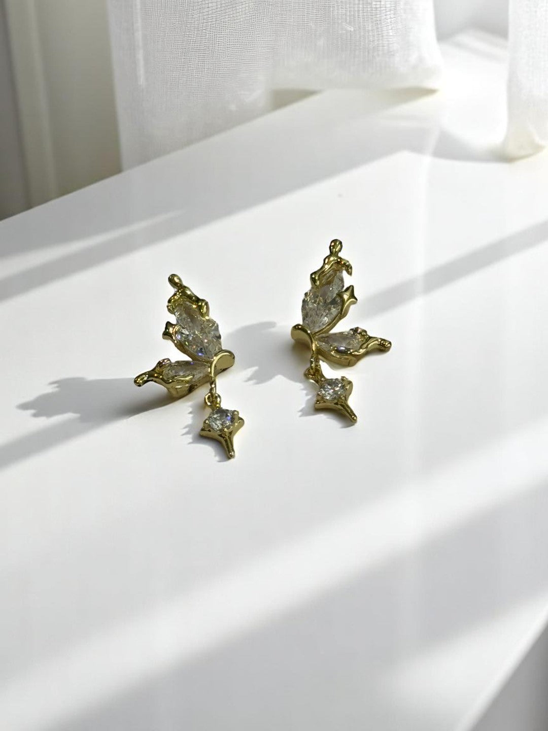 GOLDEN HANGING DIAMOND BUTTERFLY AXEL EARRINGS