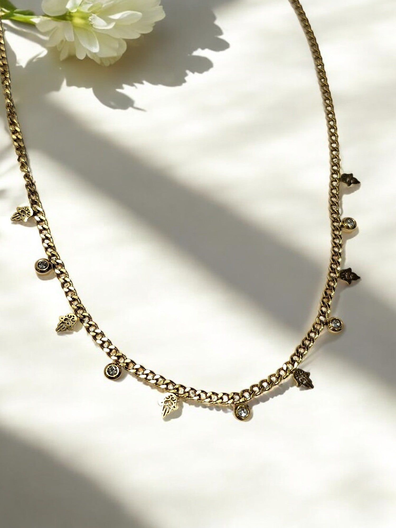 GOLDEN CHAIN WITH HANGING NONVIOLENCE SYMBOL AND HANGING DIAMOND