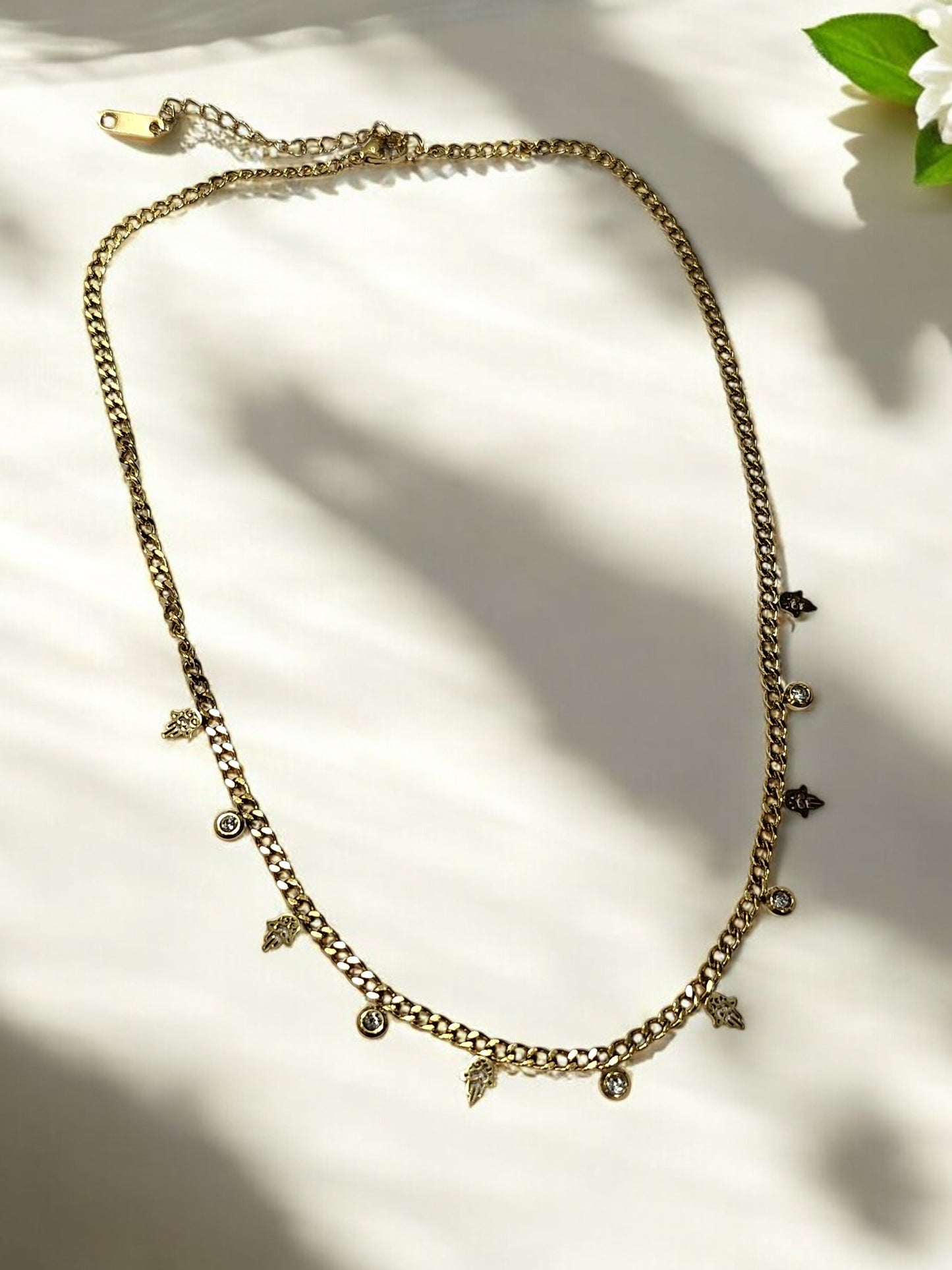GOLDEN CHAIN WITH HANGING NONVIOLENCE SYMBOL AND HANGING DIAMOND