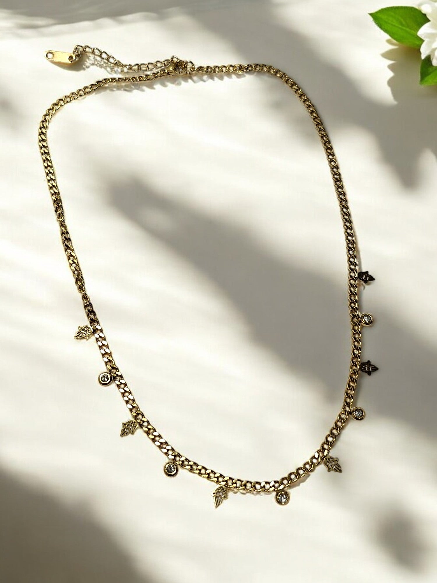 GOLDEN CHAIN WITH HANGING NONVIOLENCE SYMBOL AND HANGING DIAMOND