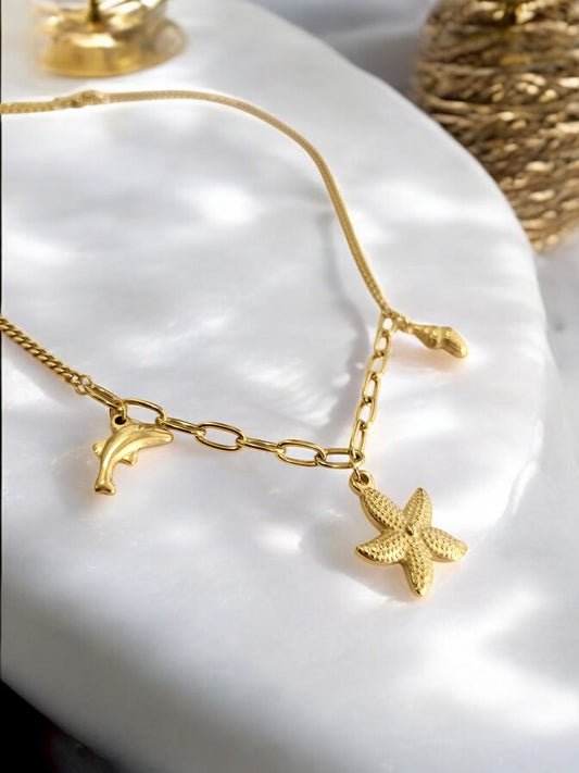 GOLDEN CHAIN WITH CHARMS LIKE DOLPHIN, STAR FISH AND TINY CONCH