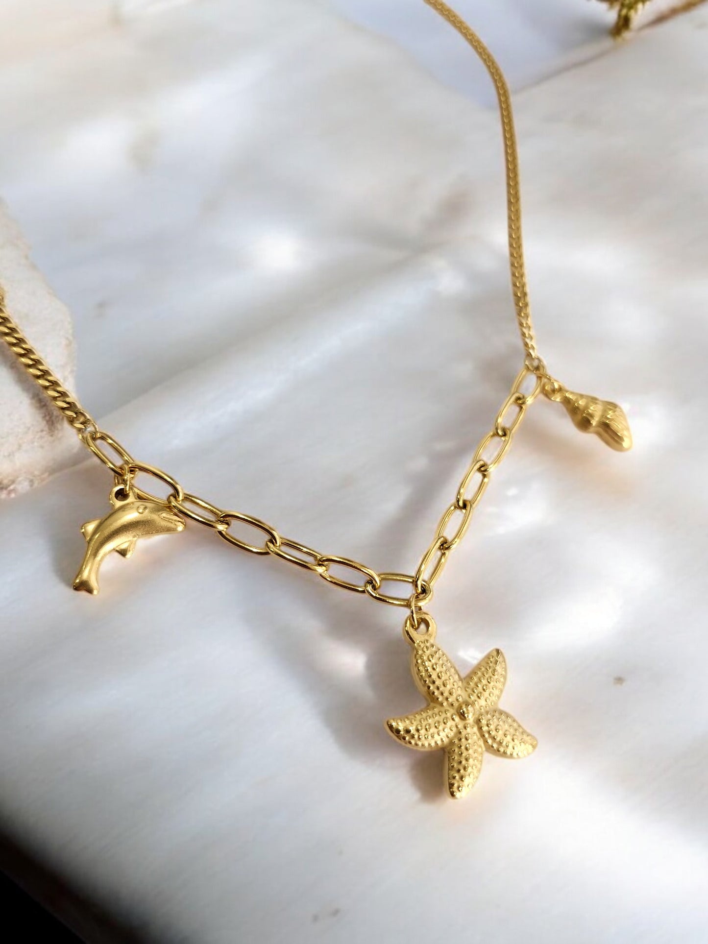 GOLDEN CHAIN WITH CHARMS LIKE DOLPHIN, STAR FISH AND TINY CONCH