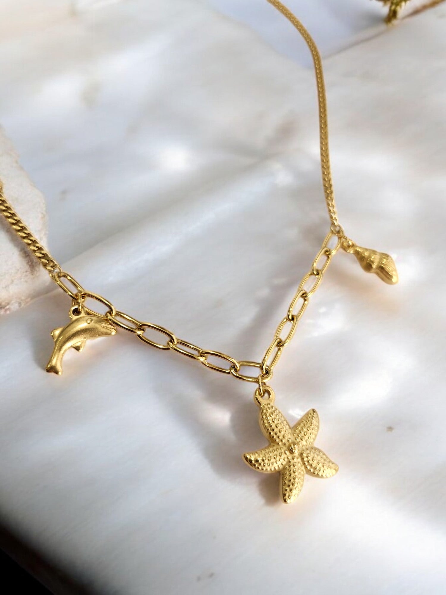 GOLDEN CHAIN WITH CHARMS LIKE DOLPHIN, STAR FISH AND TINY CONCH