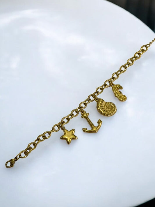 GOLDEN CHAIN BRACELET WITH CHARMS LIKE ANCHOR, STAR, SNAIL AND SEASHORE