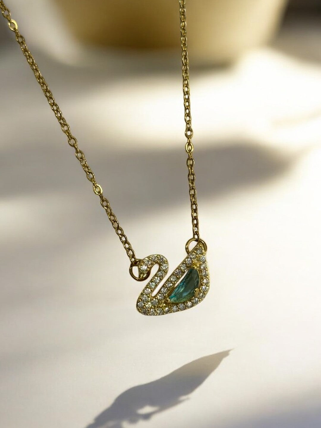 GOLDEN CHAIN WITH GREEN DIAMOND SWAN