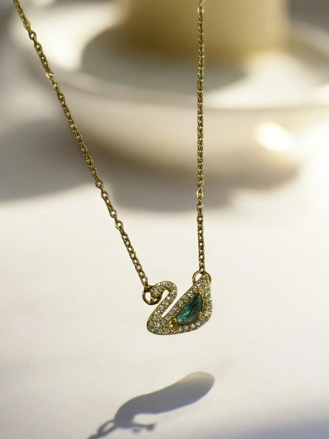 GOLDEN CHAIN WITH GREEN DIAMOND SWAN