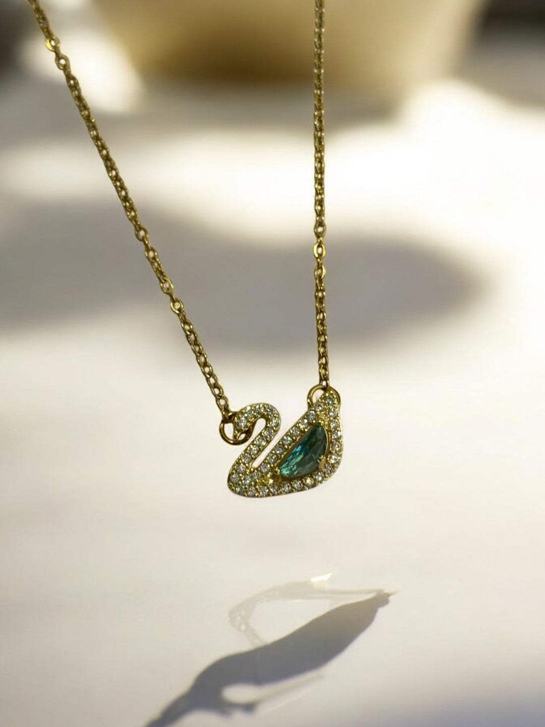 GOLDEN CHAIN WITH GREEN DIAMOND SWAN