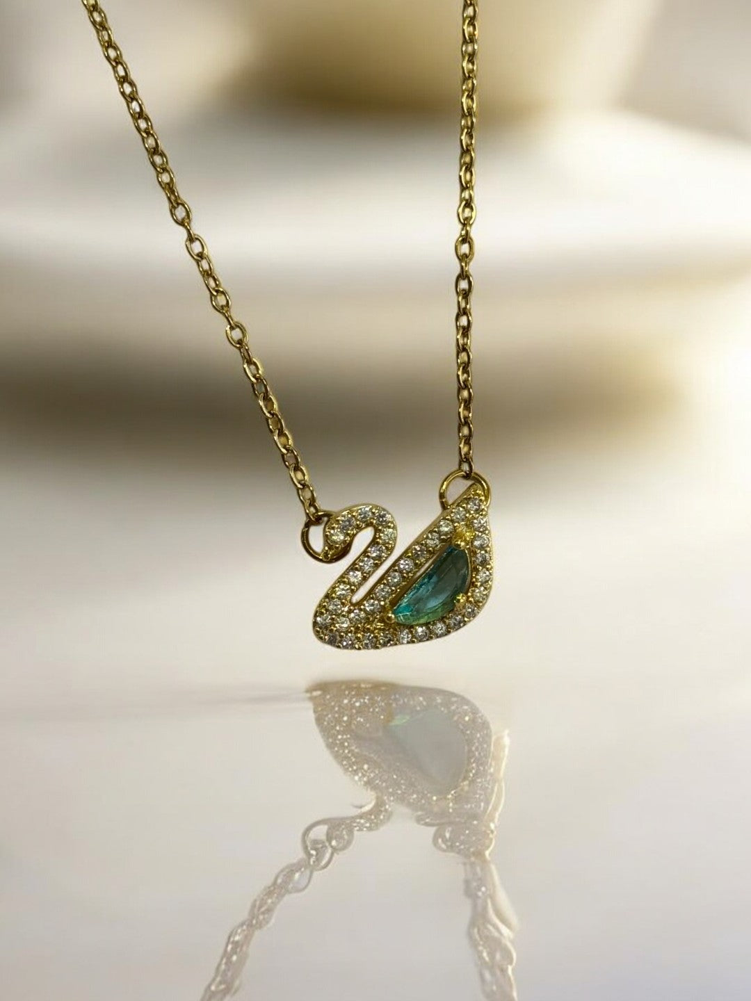 GOLDEN CHAIN WITH GREEN DIAMOND SWAN