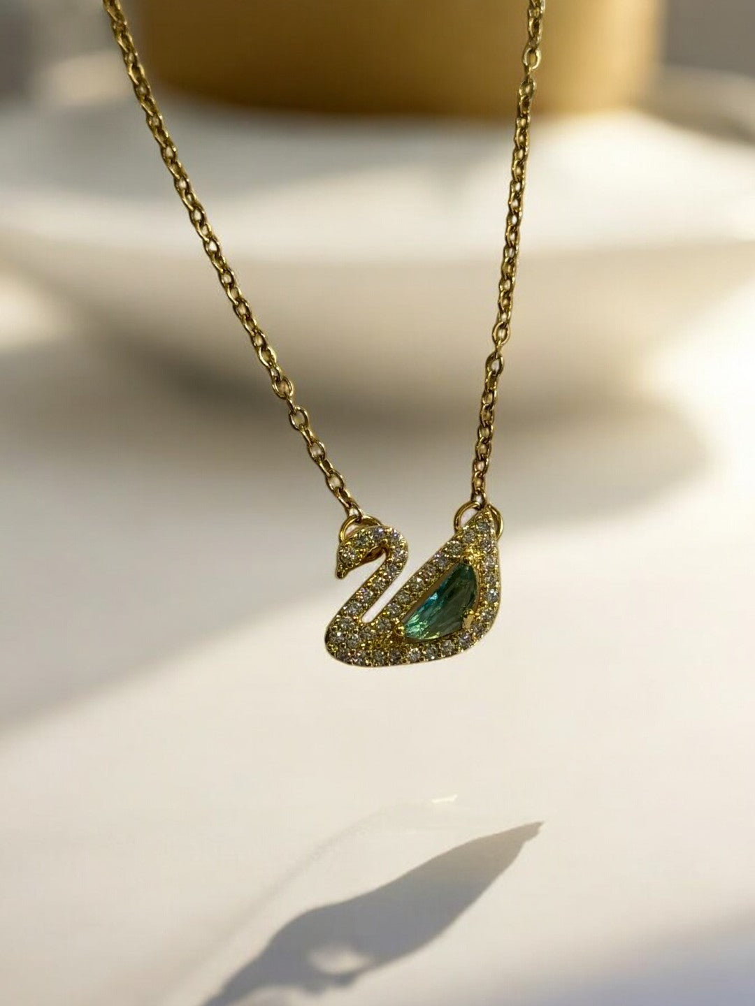 GOLDEN CHAIN WITH GREEN DIAMOND SWAN