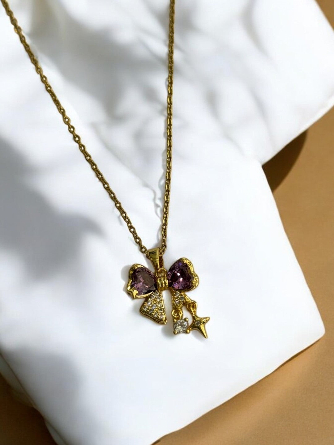 GOLDEN CHAIN WITH PURPLE DIAMOND BOW AND STAR