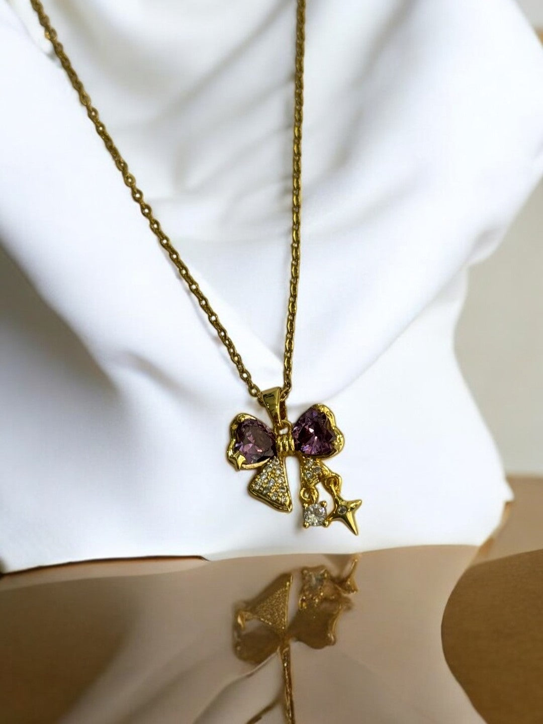 GOLDEN CHAIN WITH PURPLE DIAMOND BOW AND STAR